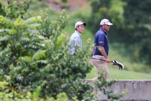 Dylan Wu and Nicholas Thompson look on as they walk across a bridge on the 9th hole during the final round of the Price Cutter Charity Championship...