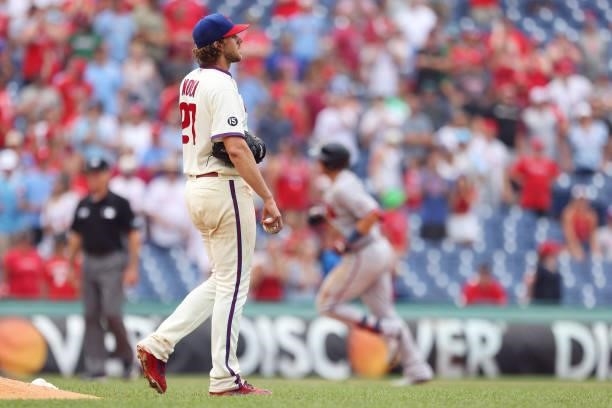 Pitcher Aaron Nola of the Philadelphia Phillies reacts as Austin Riley of the Atlanta Braves rounds the bases after hitting a home run with two outs...
