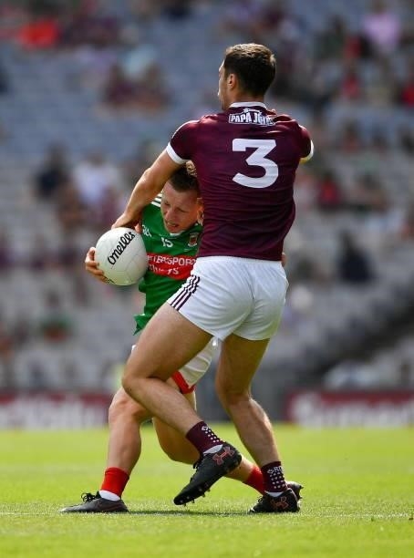Dublin , Ireland - 25 July 2021; Ryan O'Donoghue of Mayo is tackled by Seán Mulkerrin of Galway during the Connacht GAA Senior Football Championship...