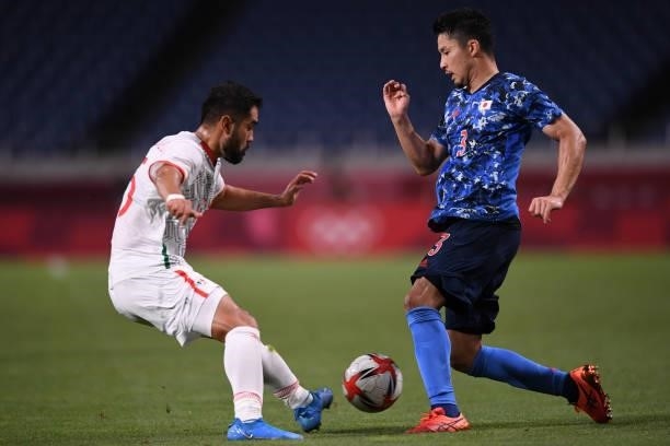 Yuta Nakayama of Team Japan dribbles the ball under the pressure from Johan Vasquez during the Men's First Round Group A match on day two of the...
