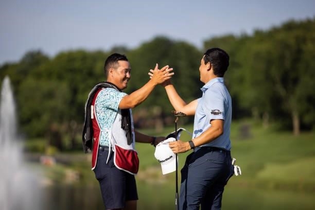 Dylan Wu Celebrates with his caddie and younger brother Jeremy Wu on the 18th green after winning the final round of the Price Cutter Charity...