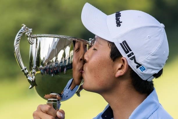 Dylan Wu poses with the Trophy on the 18th green after winning the final round of the Price Cutter Charity Championship presented by Dr. Pepper at...