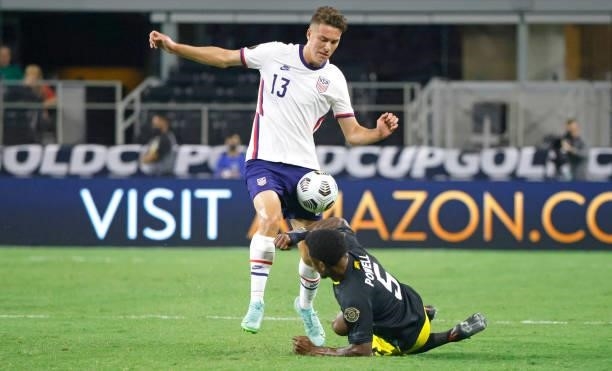 Matthew Hoppe of the United States and Alvas Powell of Jamaica fight for the ball in the first half of a 2021 CONCACAF Gold Cup Quarterfinals match...