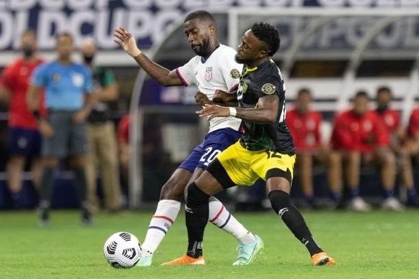 S defender Shaq Moore vies for the ball with Jamaica's forward Junior Flemmings during the Concacaf Gold Cup quarterfinal football match between USA...