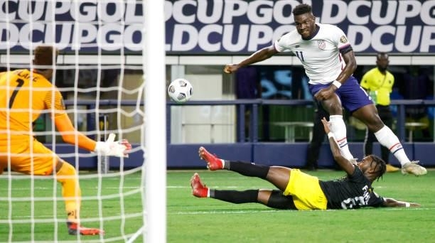 Daryl Dike of the United States takes a shot at goal as Andre Blake of Jamaica and teammate Oniel Fisher defend in the first half of a 2021 CONCACAF...