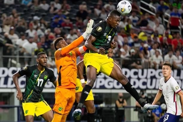 Jamaica's forward Cory Burke heads a ball near goalkeeper Andre Blake during the Concacaf Gold Cup quarterfinal football match between USA and...