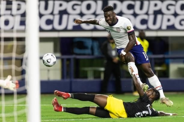 S forward Daryl Dike shoots the ball as Jamaica's defender Oniel Fisher attemps to block it during the Concacaf Gold Cup quarterfinal football match...