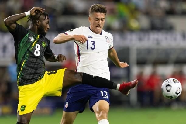 Jamaica's defender Oniel Fisher vies for the ball with USA's forward Matthew Hoppe during the Concacaf Gold Cup quarterfinal football match between...