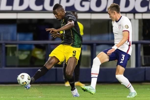 Jamaica's forward Cory Burke shoots the ball as USA's defender Sam Vines looks on during the Concacaf Gold Cup quarterfinal football match between...