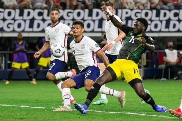 Jamaica's forward Shamar Nicholson attempts to kick the ball with USA's defender Miles Robinson nearby during the Concacaf Gold Cup quarterfinal...