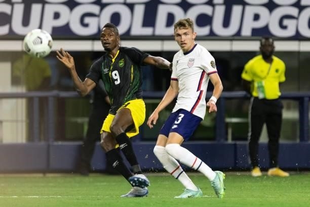 Jamaica's forward Cory Burke shoots the ball as USA's defender Sam Vines looks on during the Concacaf Gold Cup quarterfinal football match between...