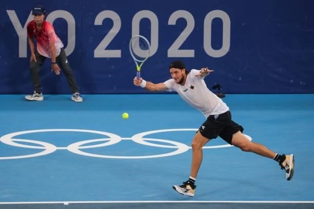 Germany's Jan-Lennard Struff returns a shot to Serbia's Novak Djokovic during their Tokyo 2020 Olympic Games men's singles second round tennis match...