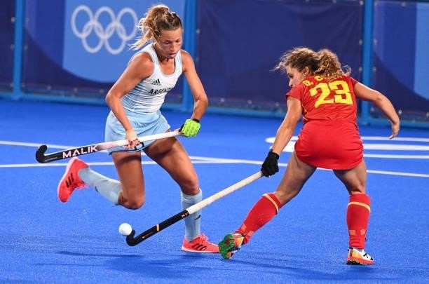 Argentina's Delfina Merino and Spain's Georgina Oliva vie for the ball during their women's pool B match of the Tokyo 2020 Olympic Games field hockey...