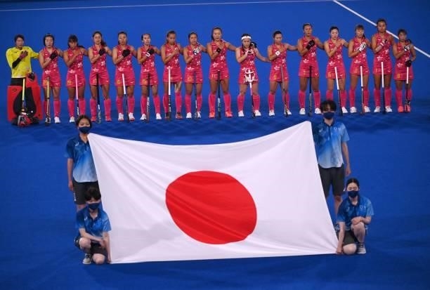 Players of Japan listen to their national anthem before the women's pool B match of the Tokyo 2020 Olympic Games field hockey competition against New...
