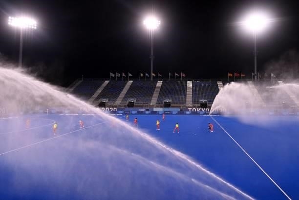 The North pitch is watered before the women's pool B match of the Tokyo 2020 Olympic Games field hockey competition between Japan and New Zealand, at...