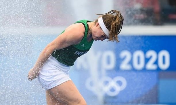 Tokyo , Japan - 26 July 2021; Sarah Torrans of Ireland runs through the water sprinkers following the women's pool A group stage match between...