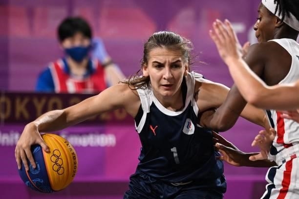 Russia's Yulia Kozik dribbles the ball as she fights for it during the women's first round 3x3 basketball match between France and Russia at the Aomi...