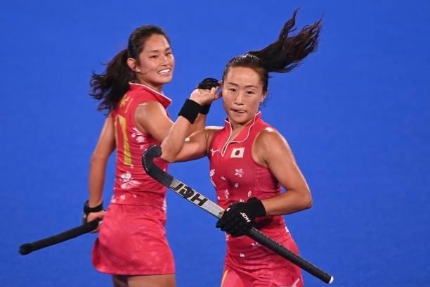 Japan's Shihori Oikawa celebrates with teammate Aki Yamada after scoring against New Zealand during their women's pool B match of the Tokyo 2020...