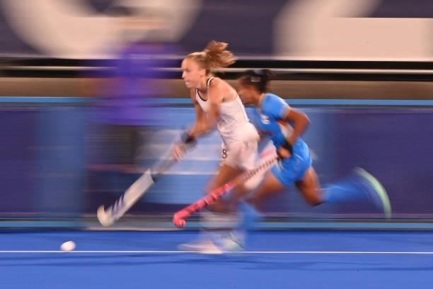 Germany's Jette Louisa Fleschutz and India's Lalremsiami vie for the ball during their women's pool A match of the Tokyo 2020 Olympic Games field...