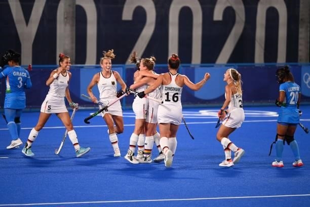 Germany's Nike Lorenz celebrates with teammates after scoring against India during their women's pool A match of the Tokyo 2020 Olympic Games field...