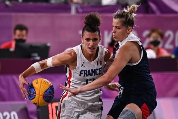 France's Laetitia Guapo fights for the ball with Russia's Evgeniia Frolkina during the women's first round 3x3 basketball match between France and...