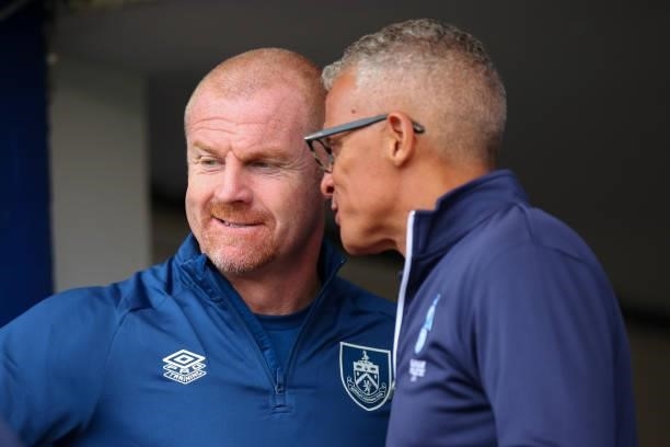 Sean Dyche the head coach / manager of Burnley talks to Keith Curle the head coach / manager of Oldham Athletic during the Pre Season Friendly match...