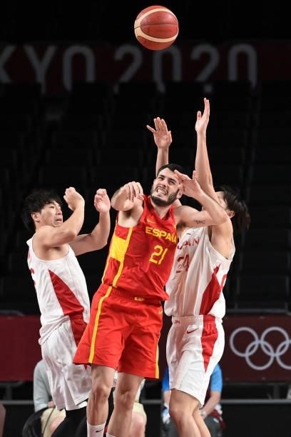 Spain's Alejandro Abrines Redondo fights for the ball with Japan's Daiki Tanaka in the men's preliminary round group C basketball match between Japan...