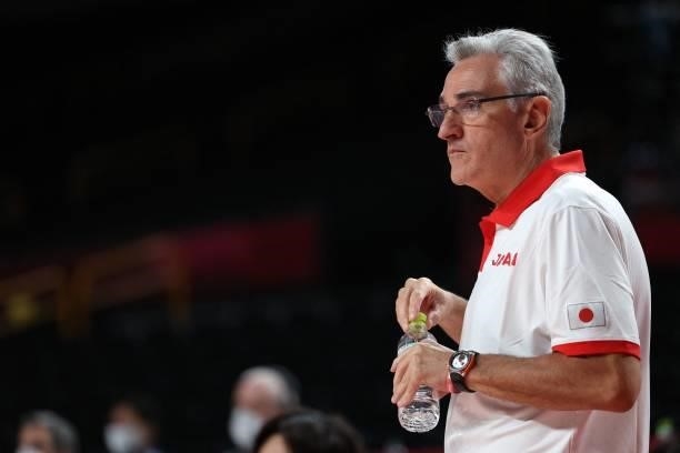 Japan's team coach Julio Lamas watches the men's preliminary round group C basketball match between Japan and Spain during the Tokyo 2020 Olympic...