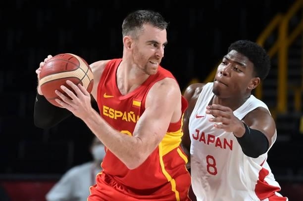 Spain's Victor Claver defends the ball from Japan's Rui Hachimura in the men's preliminary round group C basketball match between Japan and Spain...
