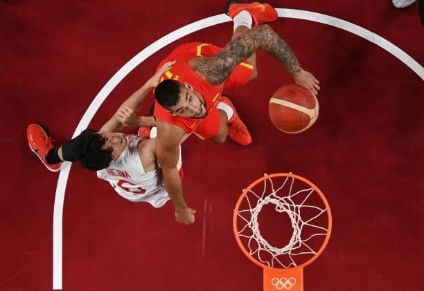 Spain's Willy Hernangomez Geuer and Japan's Makoto Hiejima fight for a rebound in the men's preliminary round group C basketball match between Japan...