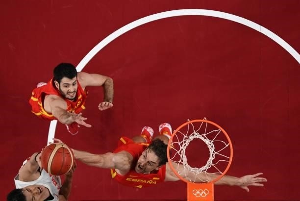 Spain's Pau Gasol Saez and Alejandro Abrines Redondo jump to block a shot by Japan's Yuta Watanabe in the men's preliminary round group C basketball...