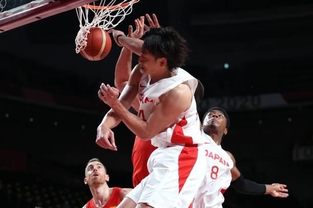 Japan's Daiki Tanaka and Rui Hachimura jump for the ball in the men's preliminary round group C basketball match between Japan and Spain during the...