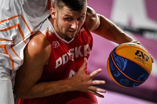 Poland's Szymon Rduch dribbles the ball during the men's first round 3x3 basketball match between Netherlands and Poland at the Aomi Urban Sports...