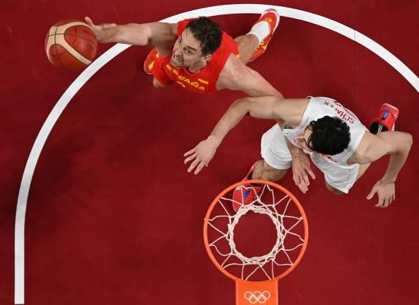 Spain's Pau Gasol Saez and Japan's Avi Koki Schafer fight for a rebound in the men's preliminary round group C basketball match between Japan and...