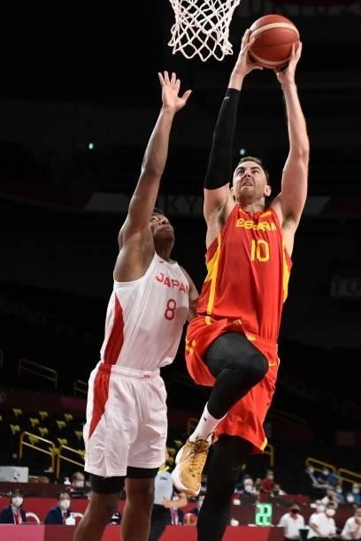 Spain's Victor Claver goes for a dunk past Japan's Rui Hachimura in the men's preliminary round group C basketball match between Japan and Spain...