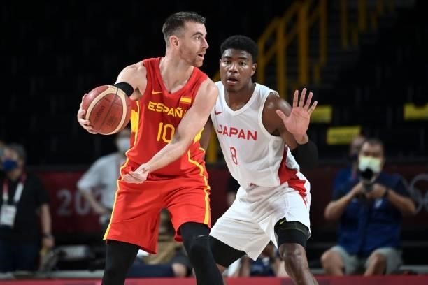 Spain's Victor Claver defends the ball from Japan's Rui Hachimura in the men's preliminary round group C basketball match between Japan and Spain...