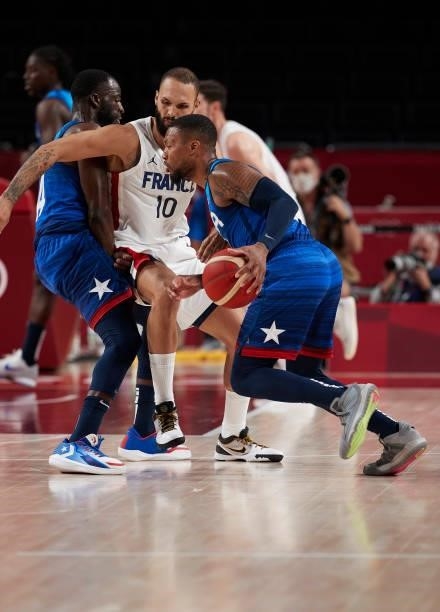 Damian Lillard of USA battle for the ball on day two in the Men's First Round Group A match between France and USA at the Tokyo 2020 Olympic Games at...