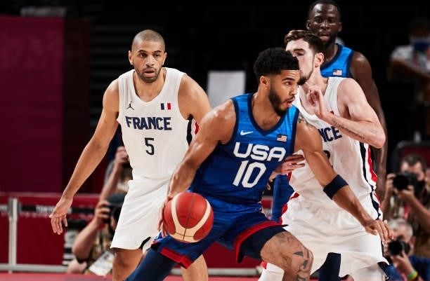Jayson Tatum of USA battle for the ball on day two in the Men's First Round Group A match between France and USA at the Tokyo 2020 Olympic Games at...