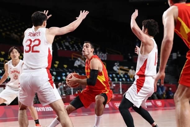 Spain's Alberto Abalde dribbles the ball past Japan's Avi Koki Schafer in the men's preliminary round group C basketball match between Japan and...