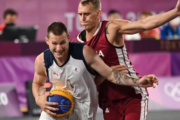 Russia's Stanislav Sharov fights for the ball with Latvia's Nauris Miezis during the men's first round 3x3 basketball match between Russia and Latvia...