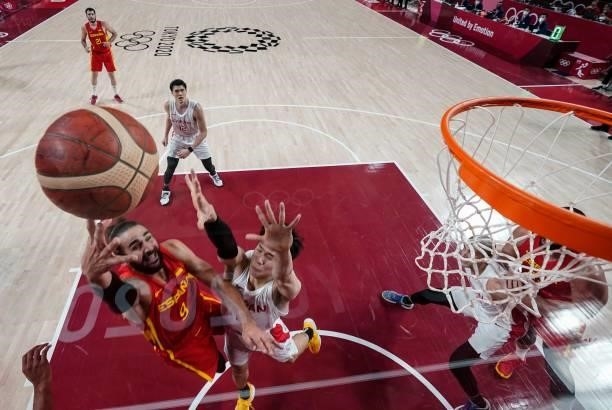Spain's Ricky Rubio goes to the basket past Japan's Yudai Baba in the men's preliminary round group C basketball match between Japan and Spain during...