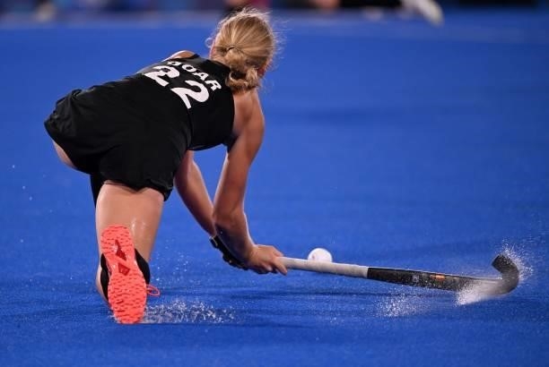 New Zealand's Katie Doar strikes the ball during the women's pool B match of the Tokyo 2020 Olympic Games field hockey competition against Japan, at...