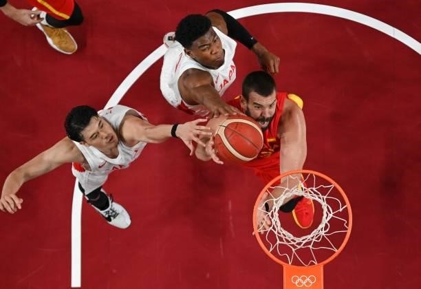 Spain's Marc Gasol fights for a rebound with Japan's Rui Hachimura and Yuta Watanabe in the men's preliminary round group C basketball match between...