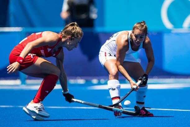 Shona McCallin of Great Britain and Lisa Altenburg of Germany compete on day two during the women's hockey group A preliminary round match between...