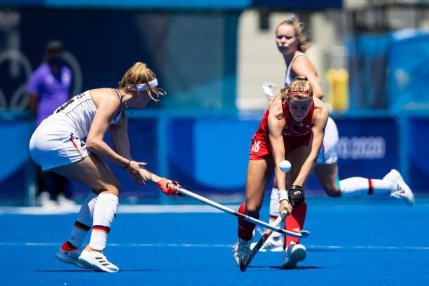 Pia Maertens of Germany and Lily Owsley of Great Britain compete on day two during the women's hockey group A preliminary round match between Great...