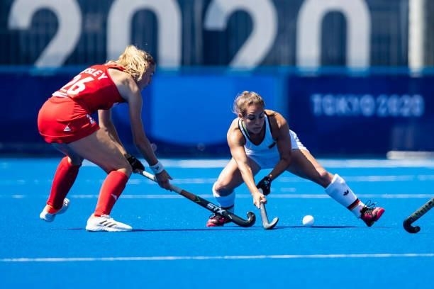 Lily Owsley of Great Britain and Lisa Altenburg of Germany compete on day two during the women's hockey group A preliminary round match between Great...