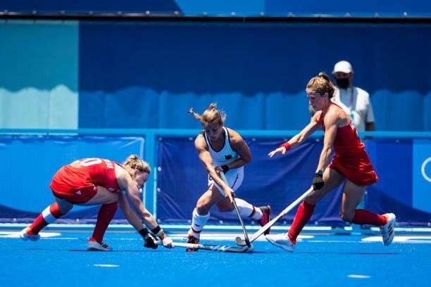 Hollie Pearne-Webb of Great Britain, Lisa Altenburg of Germany and Shona McCallin of Great Britain compete on day two during the women's hockey group...