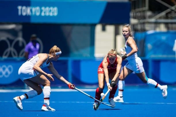 Pia Maertens of Germany and Lily Owsley of Great Britain compete on day two during the women's hockey group A preliminary round match between Great...