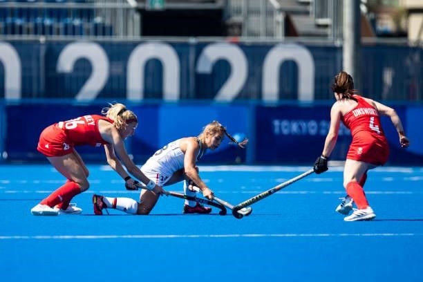 Lily Owsley of Great Britain Lisa Altenburg of Germany and Laura Unsworth of Great Britain compete on day two during the women's hockey group A...