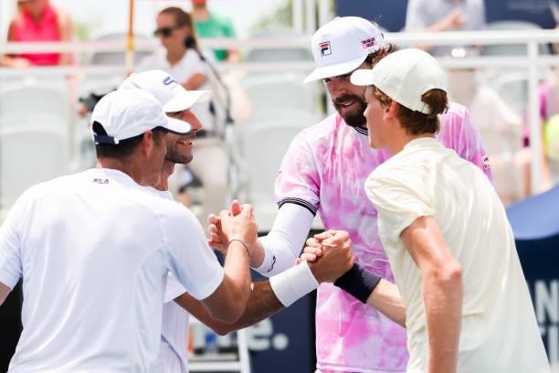 Reilly Opelka and Jannik Sinner greet Jonathan Erlich and Santiago Gonzalez after beating them in a doubles match at the Truist Atlanta Open at...